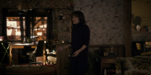 Medium shot frame from Stranger Things — standing, room, table