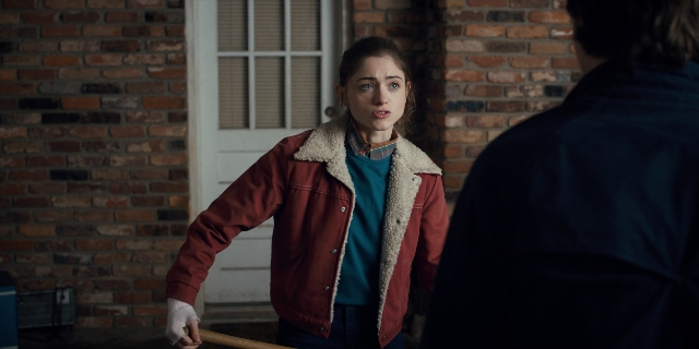 Wide shot frame from Stranger Things — standing, room, door