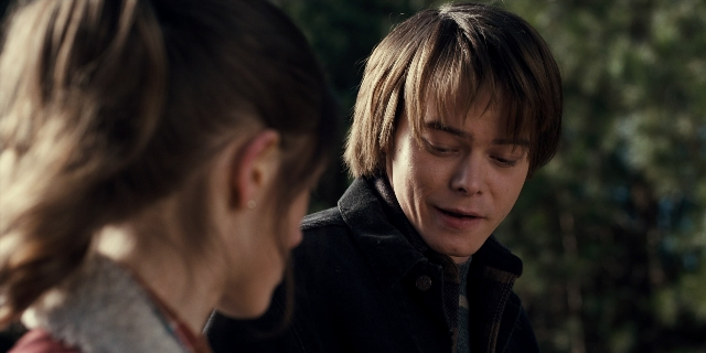 Medium shot frame from Stranger Things — standing, hair, person