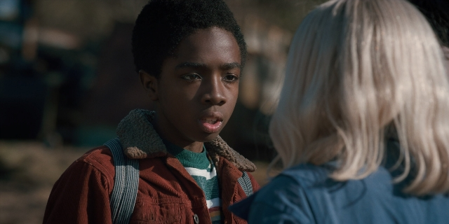 Medium shot frame from Stranger Things — standing, shirt, jacket