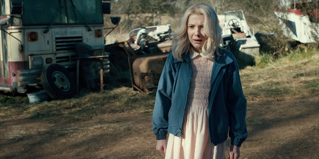 Wide shot frame from Stranger Things — standing, street, dress