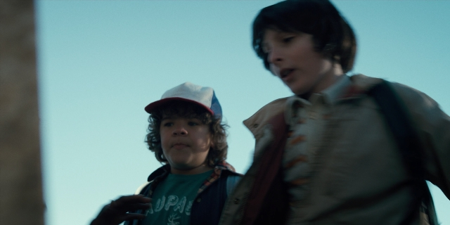 Frame from Stranger Things — standing, hat, shirt