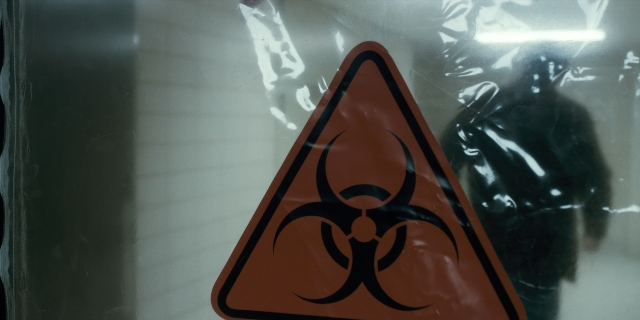 Wide shot frame from Stranger Things — room, person, traffic sign