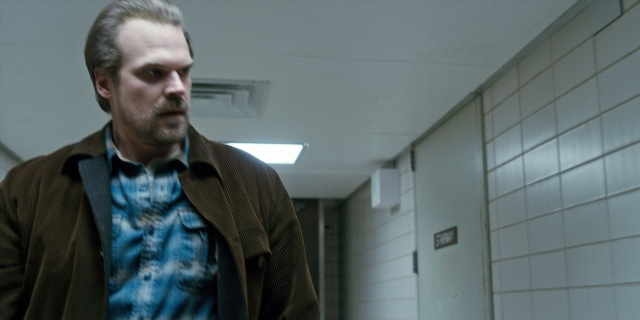 Wide shot frame from Stranger Things — standing, tie, shirt