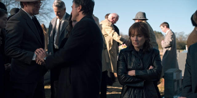 Wide shot frame from Stranger Things — standing, dialogue, coat