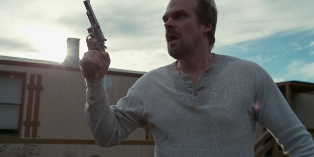 Wide shot frame from Stranger Things — standing, hand, shirt