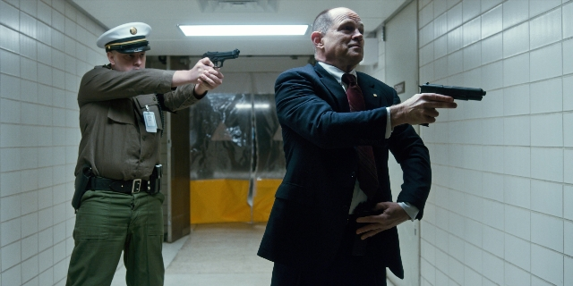 Medium shot frame from Stranger Things — standing, hat, uniform