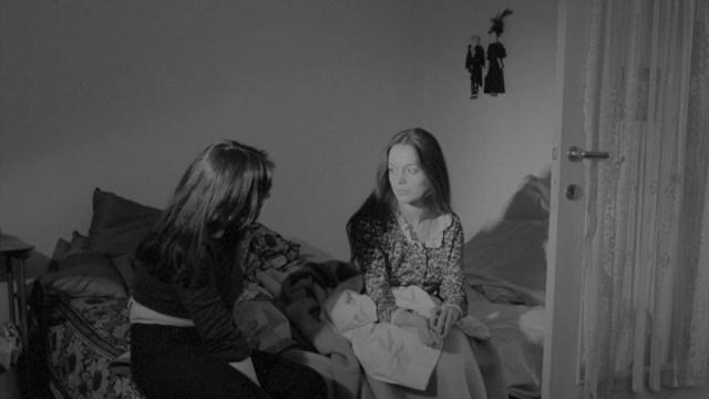 Frame from Je tu il elle — sitting, room, bed