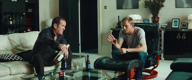 Wide shot frame from Layer Cake — sitting, room, table