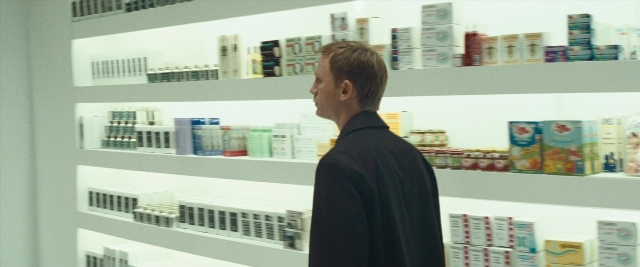 Frame from Layer Cake — standing, coat, person