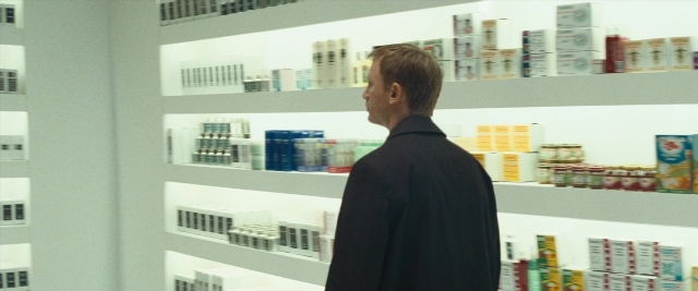 Frame from Layer Cake — standing, coat, person