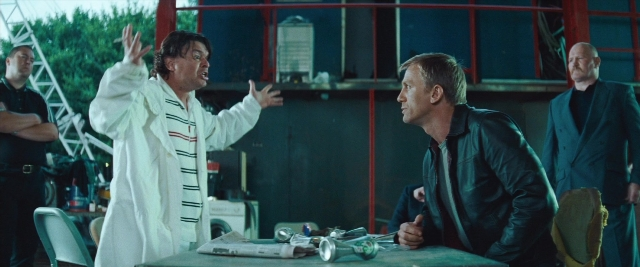 Wide shot frame from Layer Cake — standing, room, table