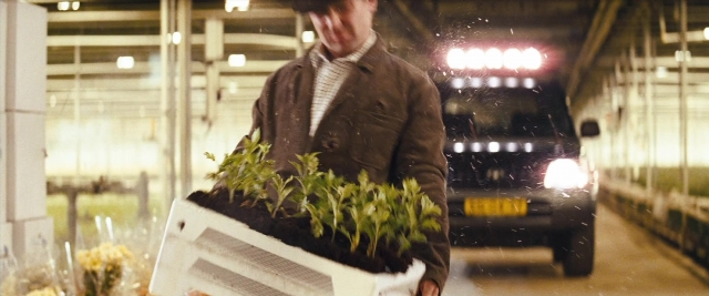 Wide shot frame from Layer Cake — standing, car, wheel