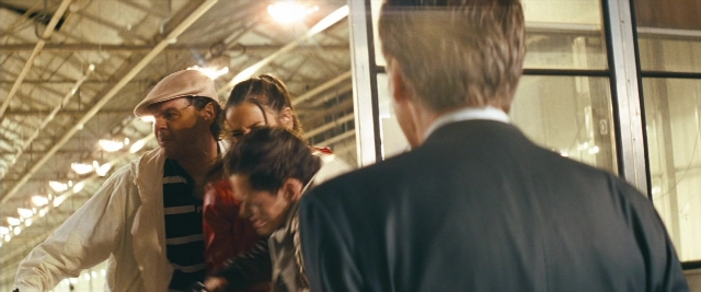 Wide shot frame from Layer Cake — standing, room, dialogue