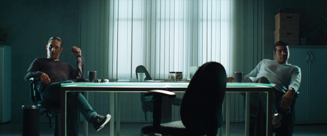 Wide shot frame from Layer Cake — sitting, room, table