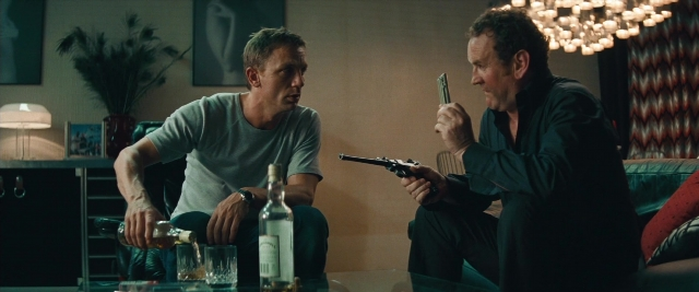 Frame from Layer Cake — sitting, room, hand