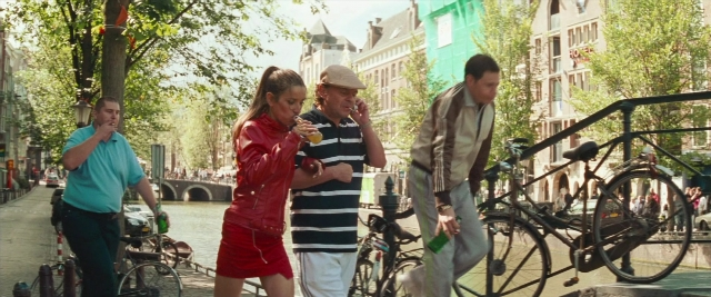Wide shot frame from Layer Cake — walking, street, hand
