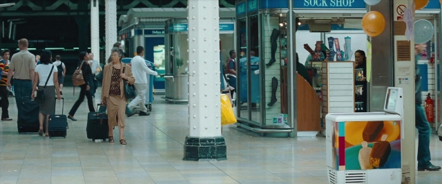 Wide shot frame from Layer Cake — walking, door, glass