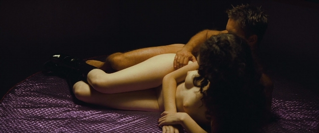 Wide shot frame from Layer Cake — bed, person, human face