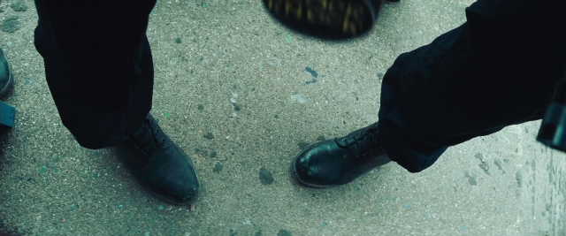 Wide shot frame from Layer Cake — standing, walking, person