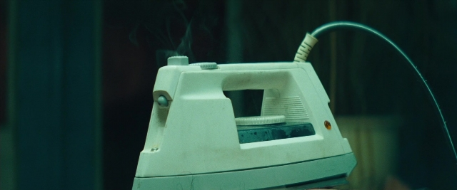 Wide shot frame from Layer Cake — room, window, home appliance