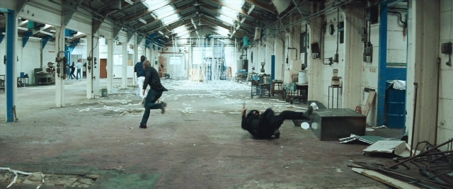 Wide shot frame from Layer Cake — walking, room, person