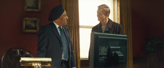 Wide shot frame from Layer Cake — standing, room, dialogue