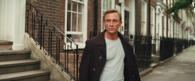Wide shot frame from Layer Cake — standing, street, coat