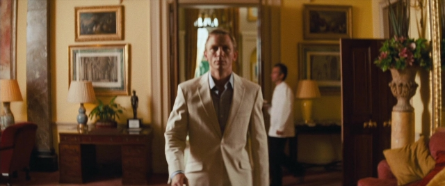 Wide shot frame from Layer Cake — standing, room, door