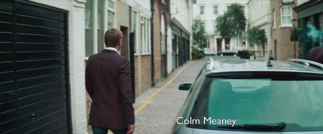 Wide shot frame from Layer Cake — walking, street, car