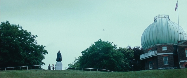 Frame from Layer Cake — standing, bird, person