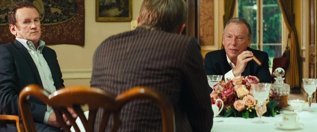 Wide shot frame from Layer Cake — sitting, room, table