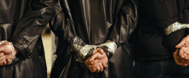 Wide shot frame from Layer Cake — standing, room, jacket