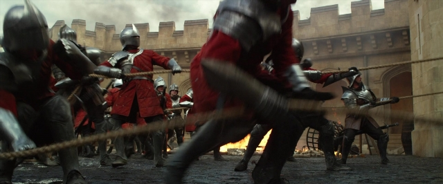 Wide shot frame from Jack the Giant Slayer — standing, fire, person