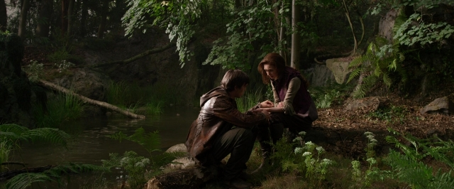 Wide shot frame from Jack the Giant Slayer — sitting, dialogue, hand