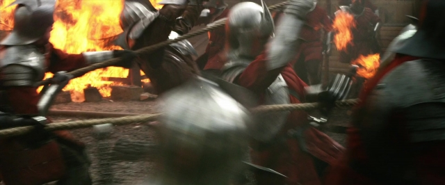 Close-up frame from Jack the Giant Slayer — fire, smoke, person
