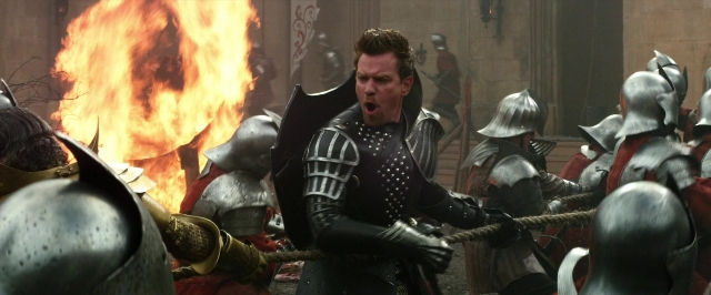 Wide shot frame from Jack the Giant Slayer — standing, fire, suit