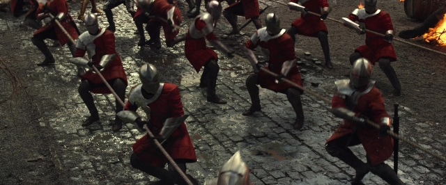 Wide shot frame from Jack the Giant Slayer — walking, street, fire