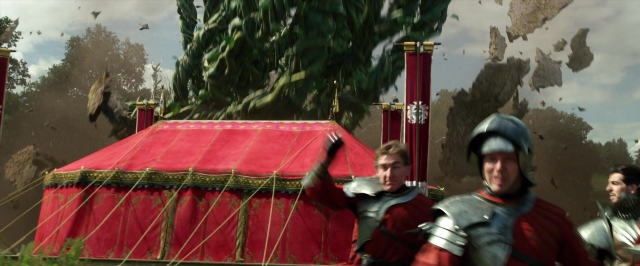 Wide shot frame from Jack the Giant Slayer — standing, hat, hand