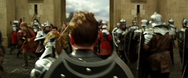 Wide shot frame from Jack the Giant Slayer — standing, walking, hat
