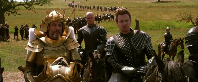 Wide shot frame from Jack the Giant Slayer — sitting, hat, suit