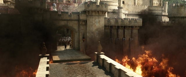Wide shot frame from Jack the Giant Slayer — walking, fire, smoke