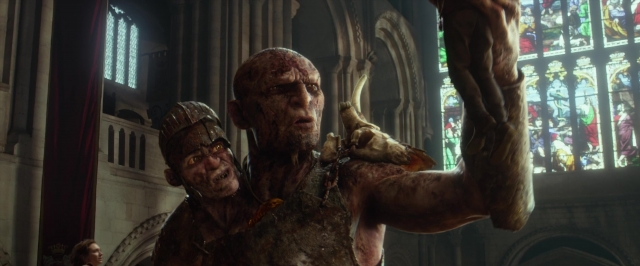Wide shot frame from Jack the Giant Slayer — standing, hat, hand