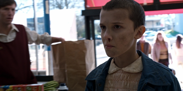 Medium shot frame from Stranger Things — standing, shirt, jacket
