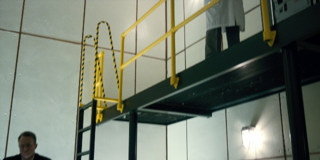Wide shot frame from Stranger Things — standing, room, shirt