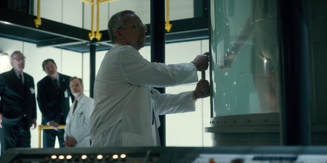 Wide shot frame from Stranger Things — standing, coat, hand