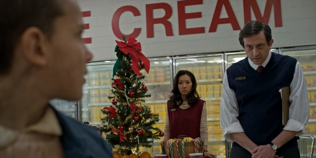 Wide shot frame from Stranger Things — standing, hand, tie