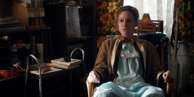 Wide shot frame from Stranger Things — sitting, room, dress