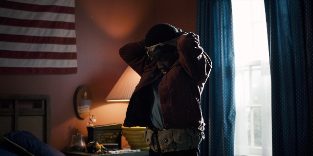 Wide shot frame from Stranger Things — standing, room, bed