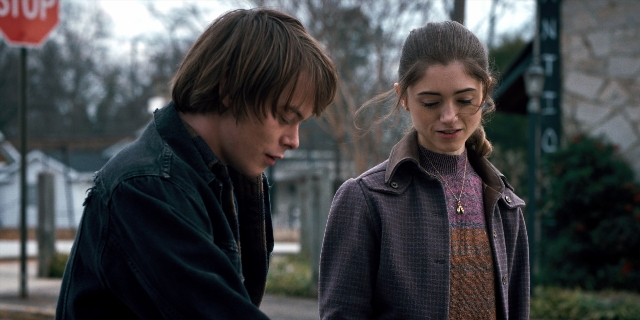 Wide shot frame from Stranger Things — standing, street, jacket